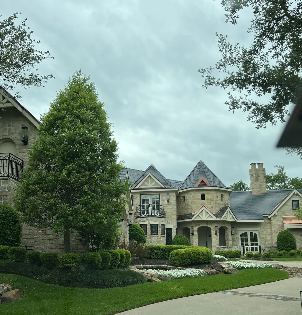 Finished slate roof with copper detailing on a custom stone home built by MAG Builders